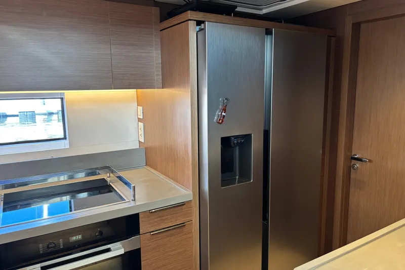 Sixty7 Yacht Photos Pics Modern kitchen interior on 2023 Lagoon SIXTY 7 yacht with stainless steel appliances.