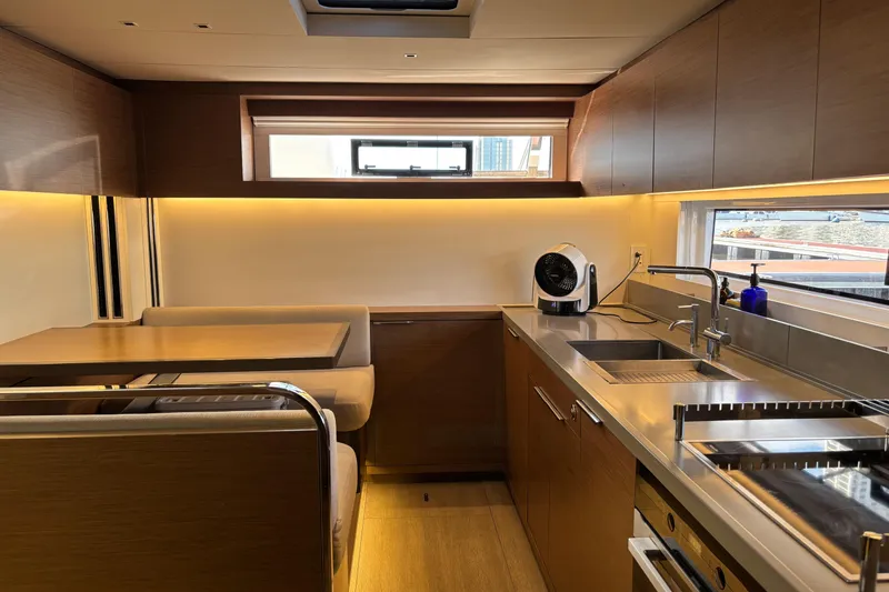 Sixty7 Yacht Photos Pics Luxurious 2023 Lagoon SIXTY 7 yacht interior with modern kitchen and dining area.