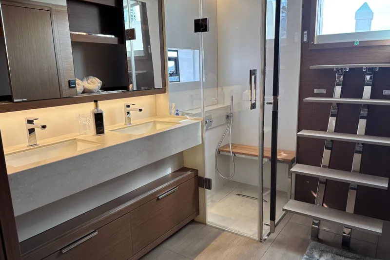 Sixty7 Yacht Photos Pics Luxurious bathroom in 2023 Lagoon SIXTY 7 yacht with dual sinks and glass shower.