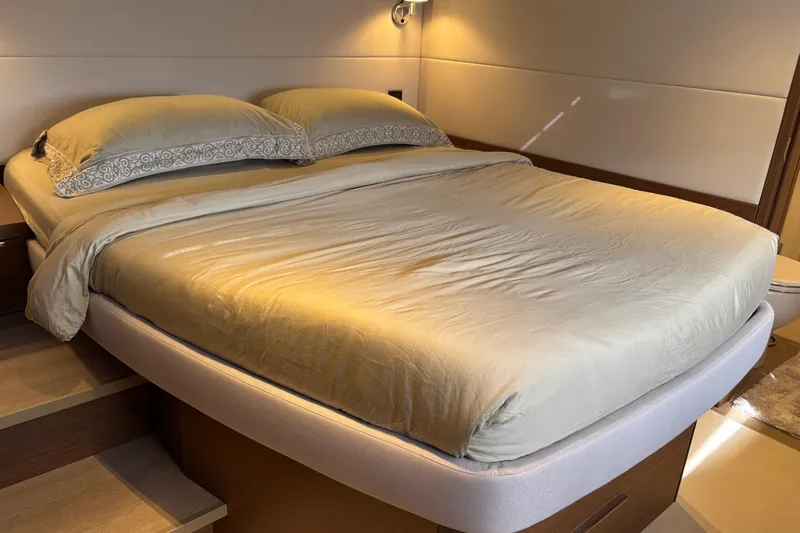 Sixty7 Yacht Photos Pics Luxurious bedroom interior of 2023 Lagoon SIXTY 7 yacht with elegant bedding.