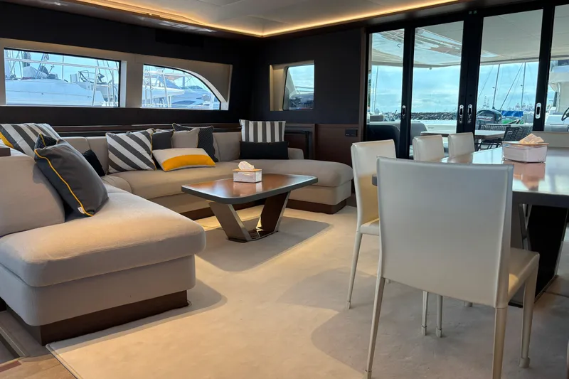Sixty7 Yacht Photos Pics Luxurious interior of 2023 Lagoon SIXTY 7 yacht with modern seating and dining area.