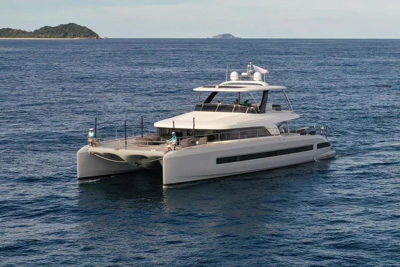 Sixty7 Yacht Photos Pics 2023 Lagoon SIXTY 7 yacht cruising on open sea near island.