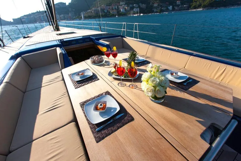  Yacht Photos Pics Luxurious dining setup on a 2005 Wally WALLY 94' yacht, with ocean view.