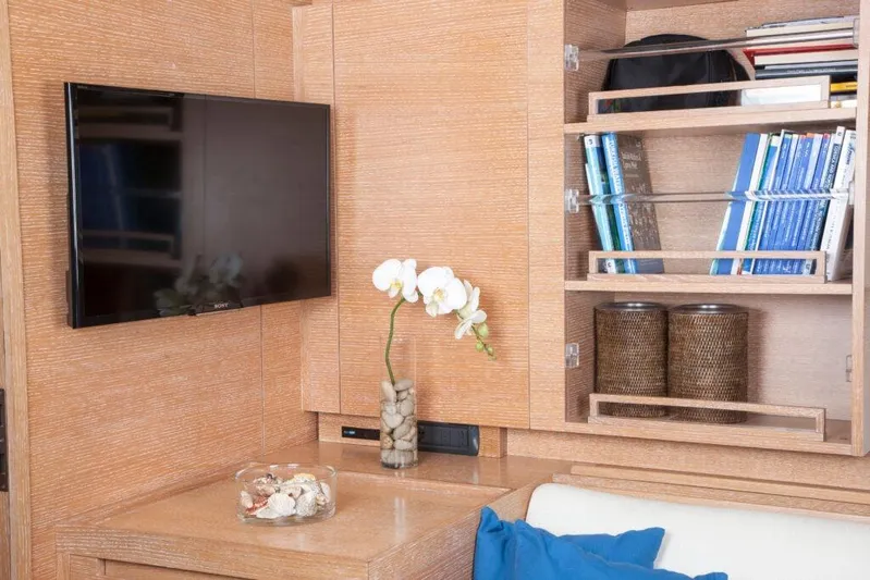  Yacht Photos Pics Luxurious yacht interior with TV, bookshelves, and elegant decor on Wally 94', 2005 model.