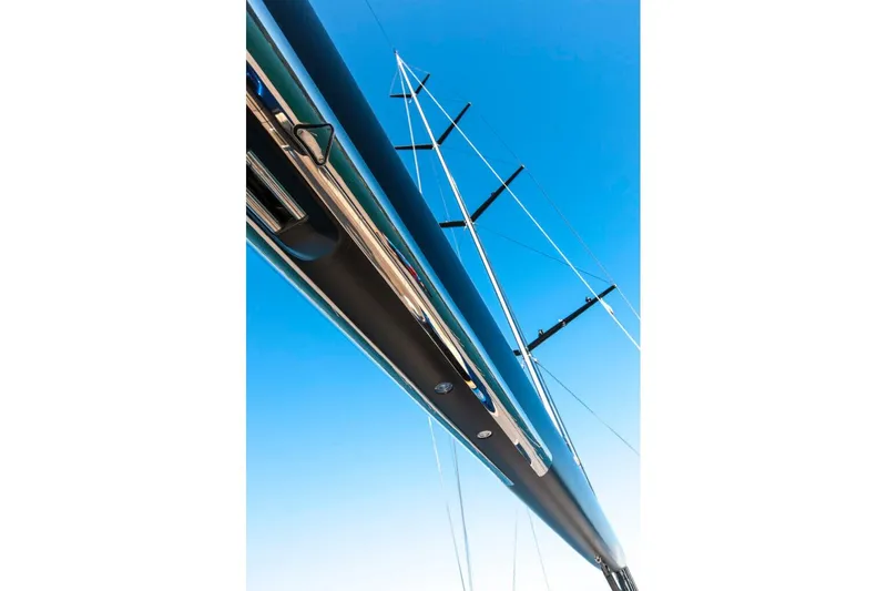  Yacht Photos Pics Tall mast of 2005 Wally WALLY 94' yacht against clear blue sky.