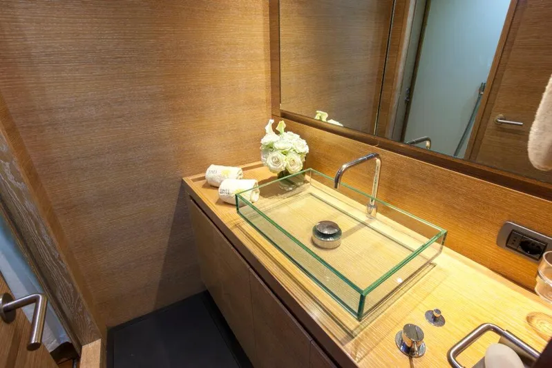  Yacht Photos Pics Luxurious yacht bathroom with glass sink, wooden accents, and elegant decor on Wally 94', 2005 model.