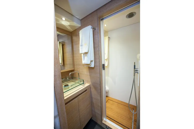  Yacht Photos Pics Luxurious bathroom in 2005 Wally 94' yacht with modern fixtures and wooden accents.