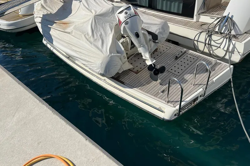  Yacht Photos Pics Prestige 620 yacht (2013) with covered outboard motor docked at marina.