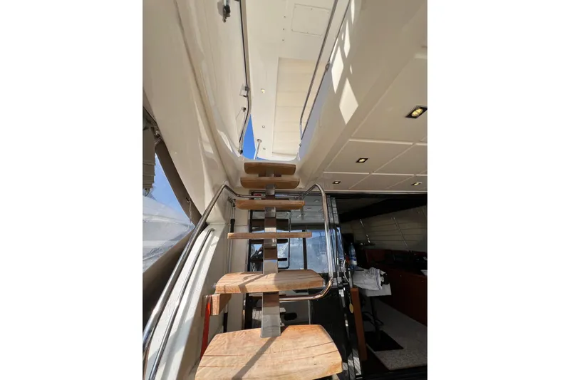  Yacht Photos Pics Interior staircase of 2013 Prestige 620 yacht, featuring wooden steps and modern design.