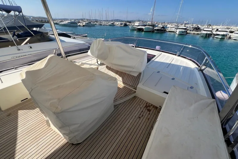  Yacht Photos Pics Luxury yacht deck of 2013 Prestige 620, featuring covered seating and marina view.