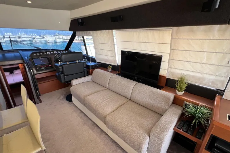  Yacht Photos Pics Luxurious interior of 2013 Prestige 620 yacht with helm, sofa, and TV.