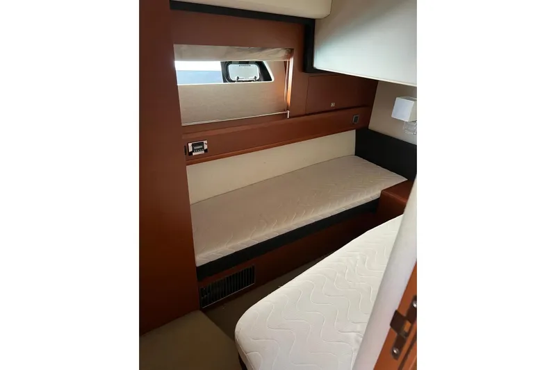  Yacht Photos Pics 2013 Prestige 620 yacht cabin with twin beds and wooden interior.