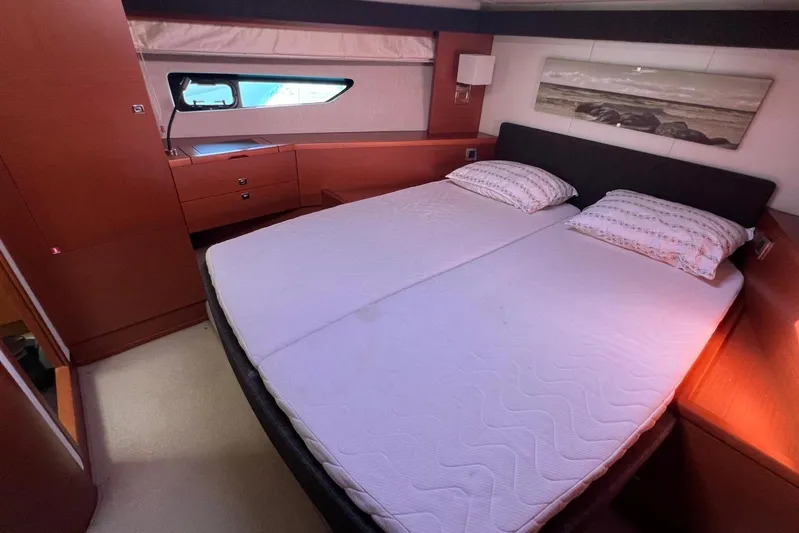  Yacht Photos Pics Luxurious bedroom interior of 2013 Prestige 620 yacht with double bed and wooden furnishings.