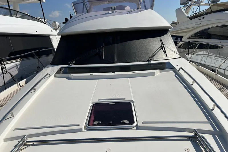  Yacht Photos Pics Front deck of a 2013 Prestige 620 yacht, docked with clear skies.