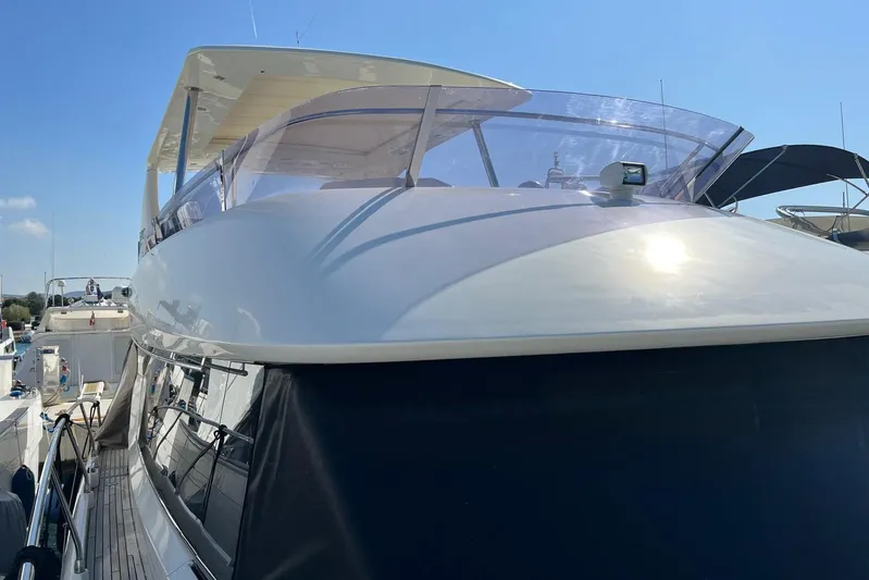  Yacht Photos Pics 2013 Prestige 620 yacht with sleek design, docked under clear blue sky.