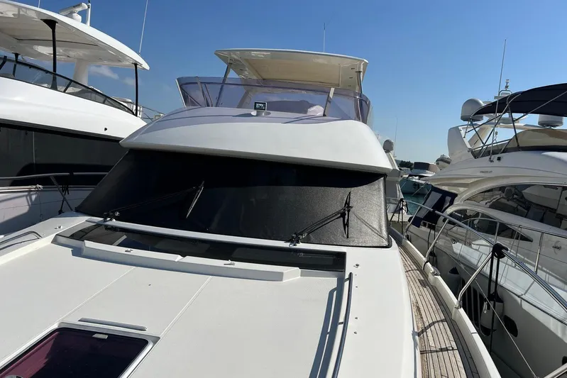  Yacht Photos Pics 2013 Prestige 620 yacht docked among other luxury boats under clear blue sky.