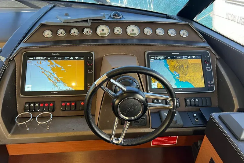  Yacht Photos Pics Cockpit of 2013 Prestige 620 yacht with navigation screens and steering wheel.
