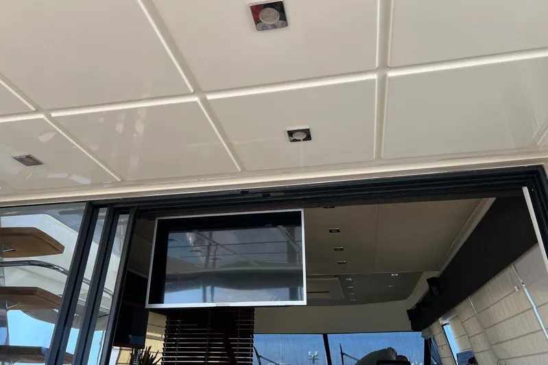  Yacht Photos Pics Interior view of a 2013 Prestige 620 yacht, featuring a modern ceiling and sliding glass door.