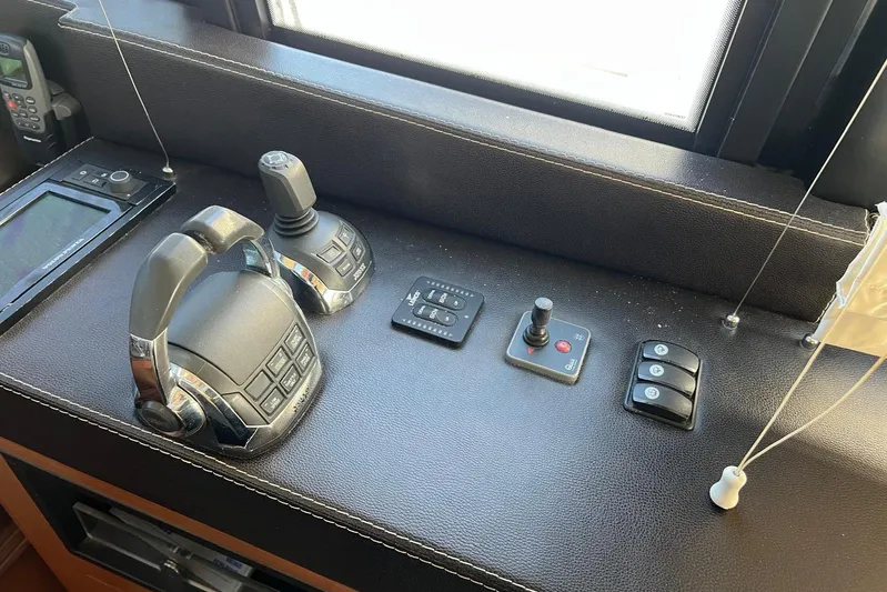  Yacht Photos Pics Control panel of a 2013 Prestige 620 yacht with joystick and throttle controls.
