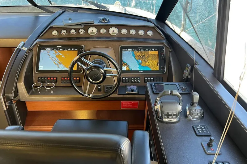  Yacht Photos Pics Cockpit of 2013 Prestige 620 yacht with navigation screens and controls.