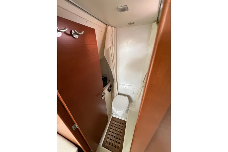  Yacht Photos Pics Compact bathroom in 2013 Prestige 620 yacht with wooden door and modern fixtures.