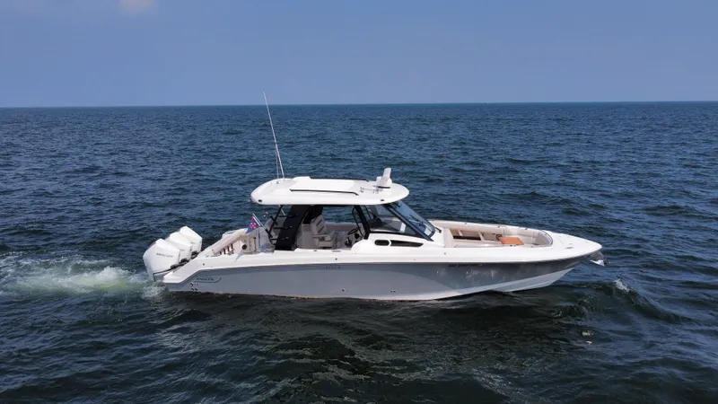  Yacht Photos Pics 2022 Boston Whaler 350 Realm cruising on open water under clear skies.