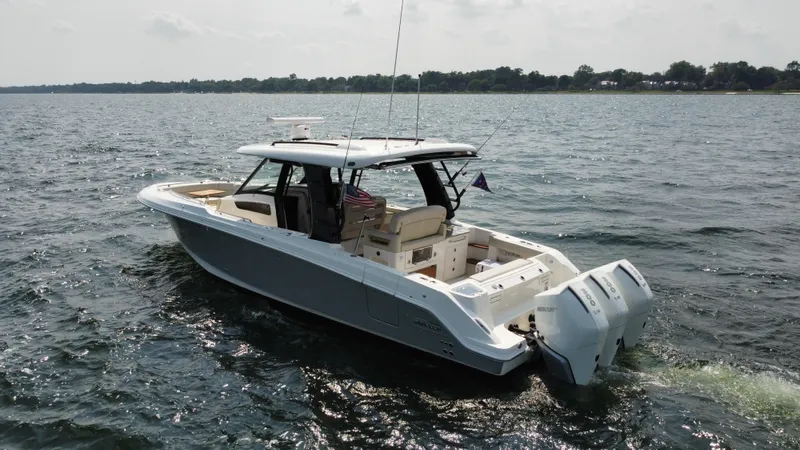  Yacht Photos Pics 2022 Boston Whaler 350 Realm boat cruising on a calm lake.