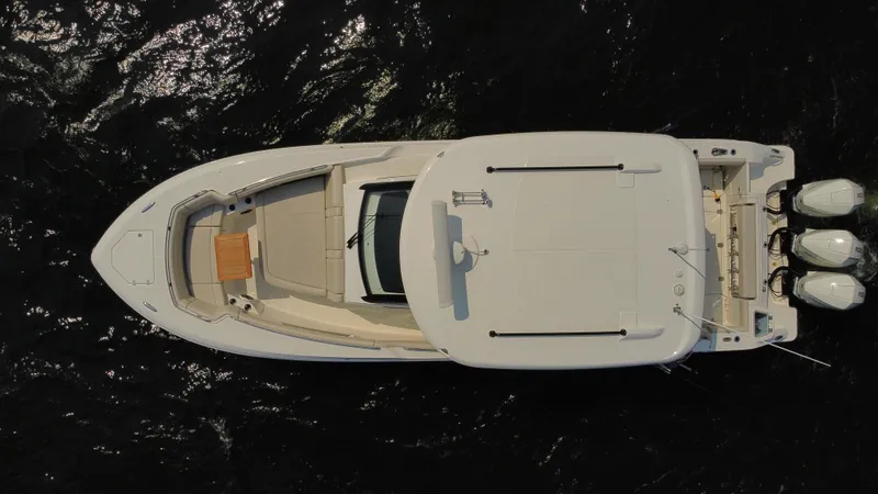  Yacht Photos Pics Aerial view of 2022 Boston Whaler 350 Realm boat on dark water.