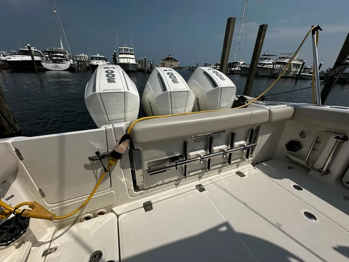  Yacht Photos Pics 2022 Boston Whaler 350 Realm with triple outboard engines docked at marina.