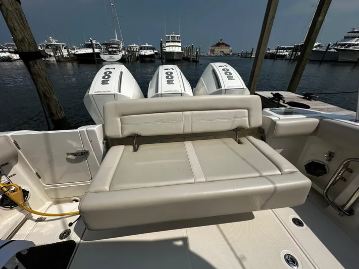  Yacht Photos Pics 2022 Boston Whaler 350 Realm boat with triple outboard engines at a marina.