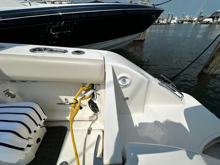  Yacht Photos Pics Boston Whaler 350 Realm 2022 boat docked, showing interior seating and equipment.