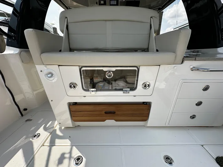  Yacht Photos Pics 2022 Boston Whaler 350 Realm interior with seating and storage compartments.