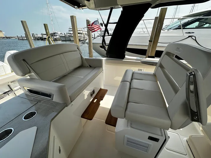  Yacht Photos Pics Boston Whaler 350 Realm 2022 boat interior with seating and dock view.
