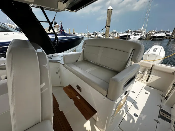  Yacht Photos Pics 2022 Boston Whaler 350 Realm interior with plush seating at marina.