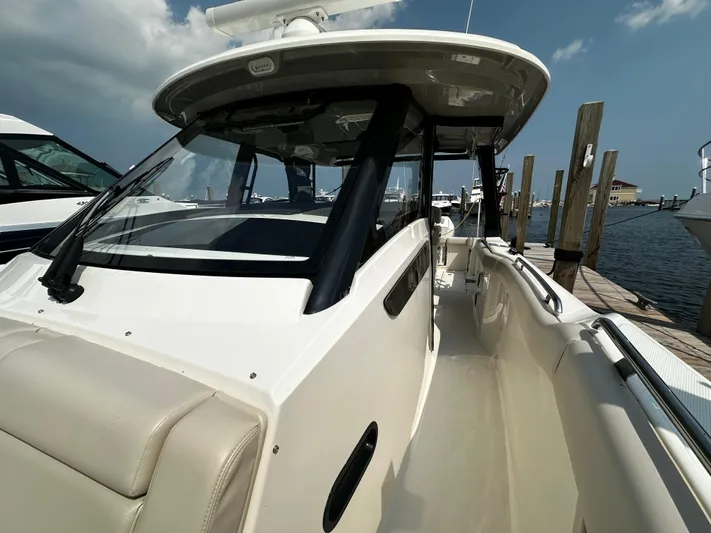 Yacht Photos Pics 2022 Boston Whaler 350 Realm boat docked at marina under clear sky.