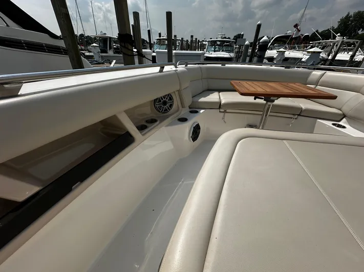 Yacht Photos Pics Boston Whaler 350 Realm 2022 boat interior with seating and wooden table.