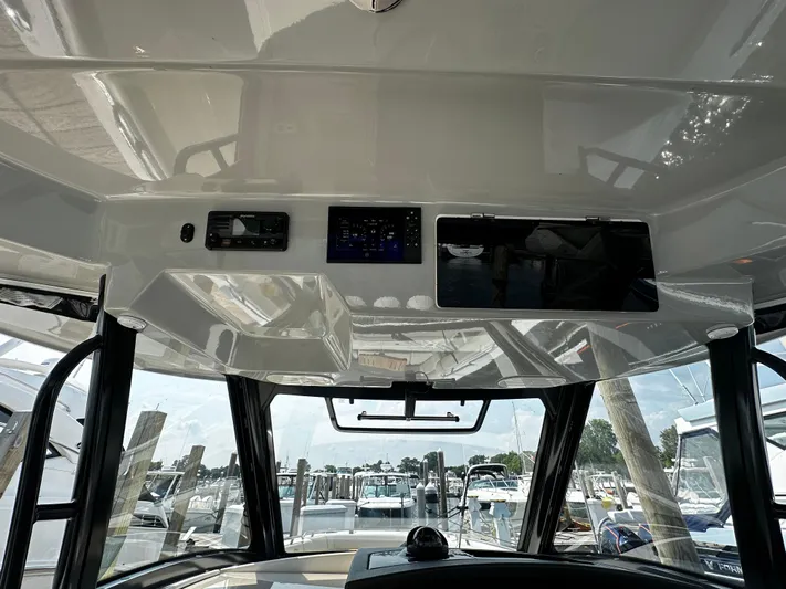  Yacht Photos Pics 2022 Boston Whaler 350 Realm helm with modern controls and marina view.