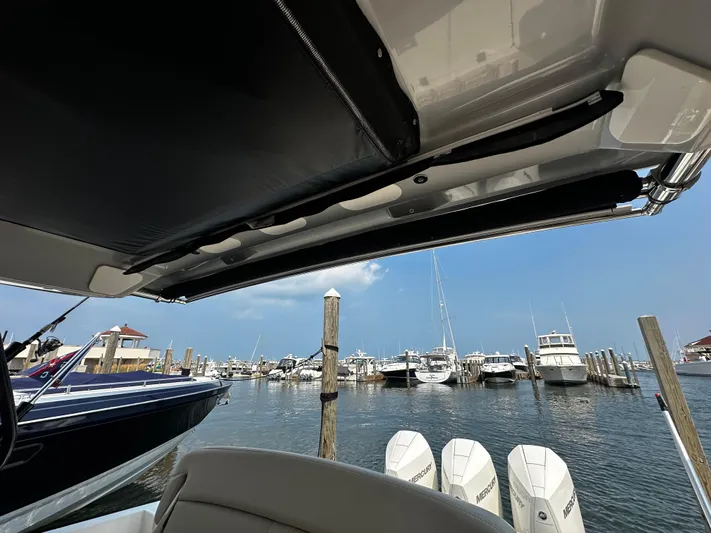  Yacht Photos Pics Boston Whaler 350 Realm 2022 at marina with multiple boats and clear sky.