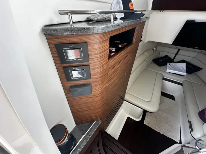  Yacht Photos Pics 2022 Boston Whaler 350 Realm cabin interior with wood paneling and seating area.