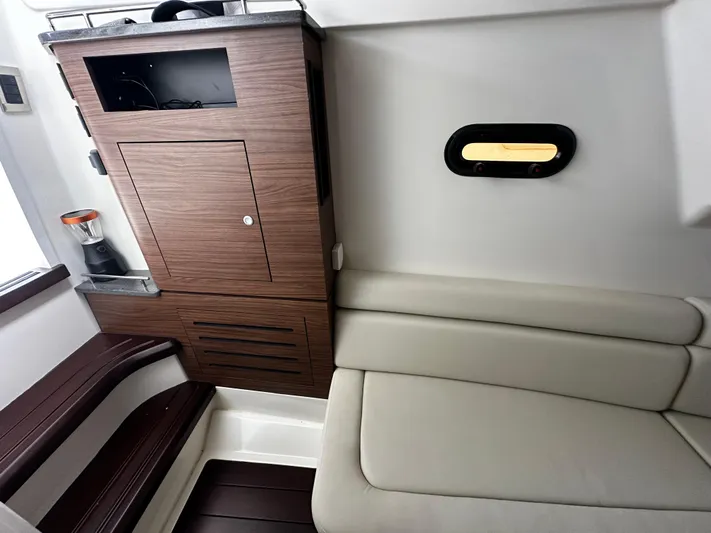  Yacht Photos Pics Interior of 2022 Boston Whaler 350 Realm, featuring wood cabinetry and cushioned seating.