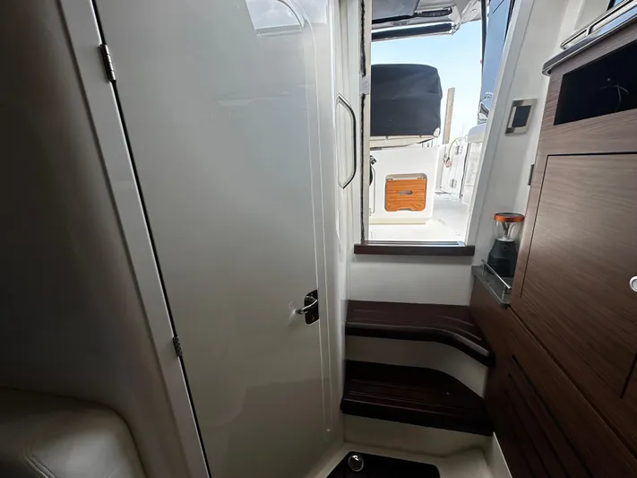  Yacht Photos Pics Interior view of 2022 Boston Whaler 350 Realm boat, featuring sleek design and wooden accents.