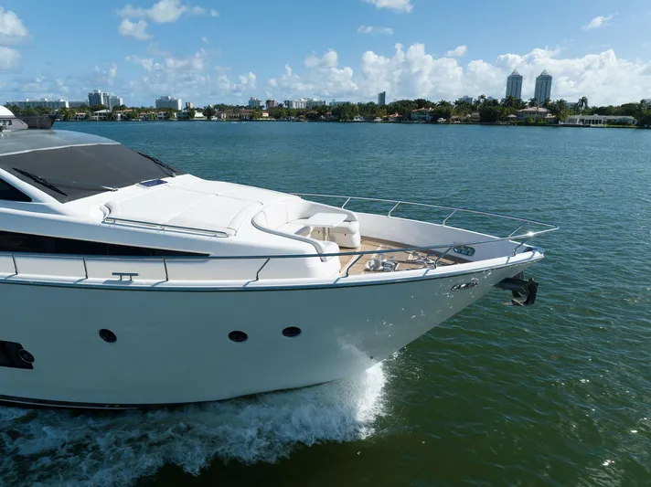 Evolution Yacht Photos Pics Luxurious 2013 Ferretti Yachts 800 cruising on a sunny day, near a city skyline.