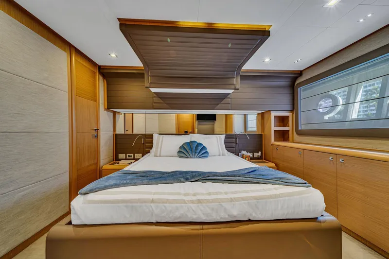 Evolution Yacht Photos Pics Luxurious bedroom interior of 2013 Ferretti Yachts 800, featuring elegant wood finishes and modern design.