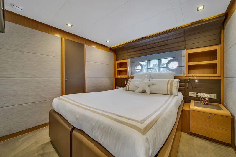 Evolution Yacht Photos Pics Luxurious bedroom interior of 2013 Ferretti Yachts 800, featuring elegant wood finishes and modern design.