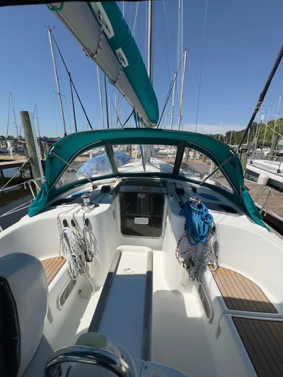  Yacht Photos Pics 2000 Beneteau 411 sailboat cockpit with teal canopy and mooring lines.