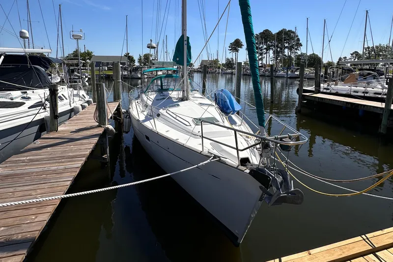  Yacht Photos Pics 2000 Beneteau 411 sailboat docked at marina, surrounded by other boats.