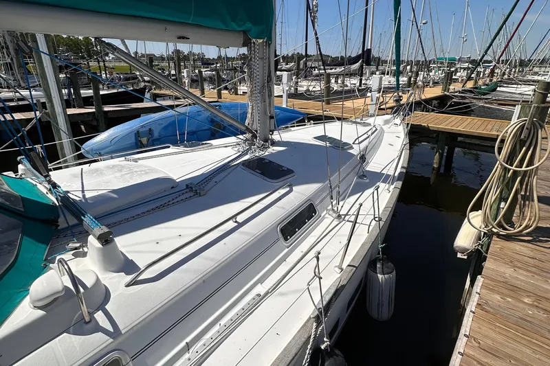  Yacht Photos Pics 2000 Beneteau 411 sailboat docked at marina, featuring white deck and teal accents.