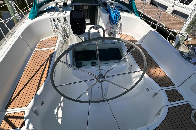  Yacht Photos Pics Cockpit of 2000 Beneteau 411 sailboat with wooden deck and steering wheel.