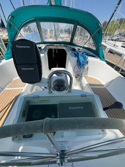  Yacht Photos Pics Cockpit of a 2000 Beneteau 411 sailboat with Raymarine equipment and teal canopy.