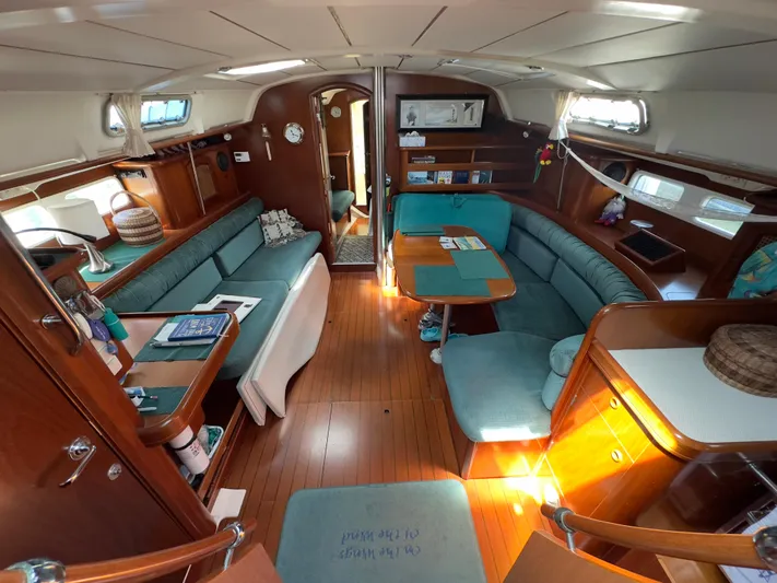  Yacht Photos Pics Interior of a 2000 Beneteau 411 sailboat with wood finish and teal seating.